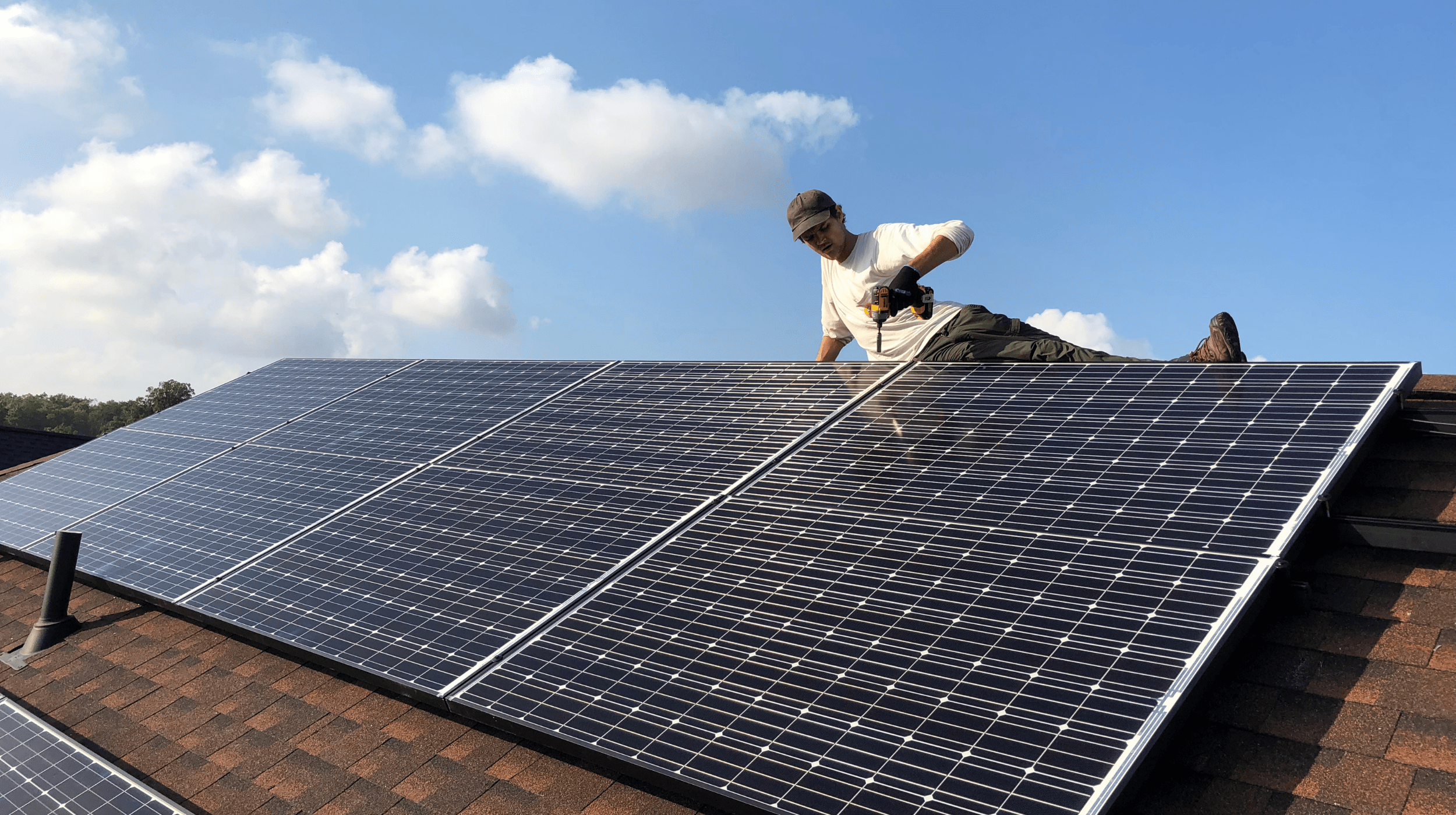 Strawberry solar worker on a roof with solar panels